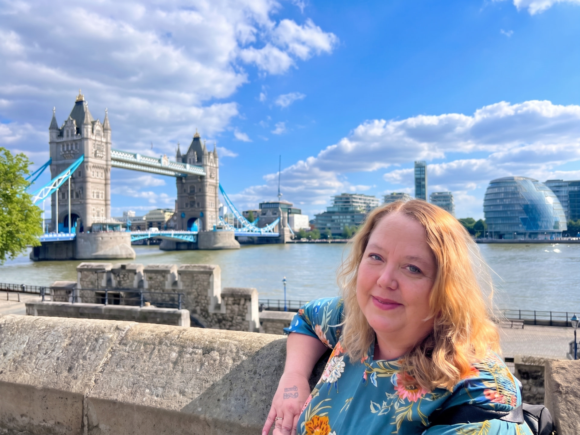 Christine beside the River Thames with Tower Bridge in the background in London