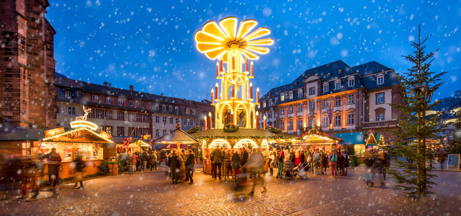 Heidelberg Christmas market with a lit Christmas pyramid in the old town square