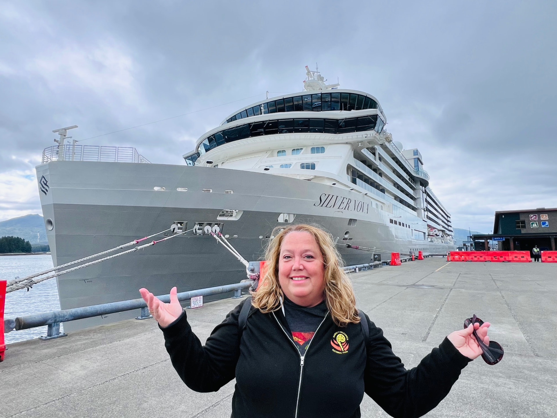 Christine on the pier in Ketchikan, Alaska with Silversea's Silver Nova docked behind her
