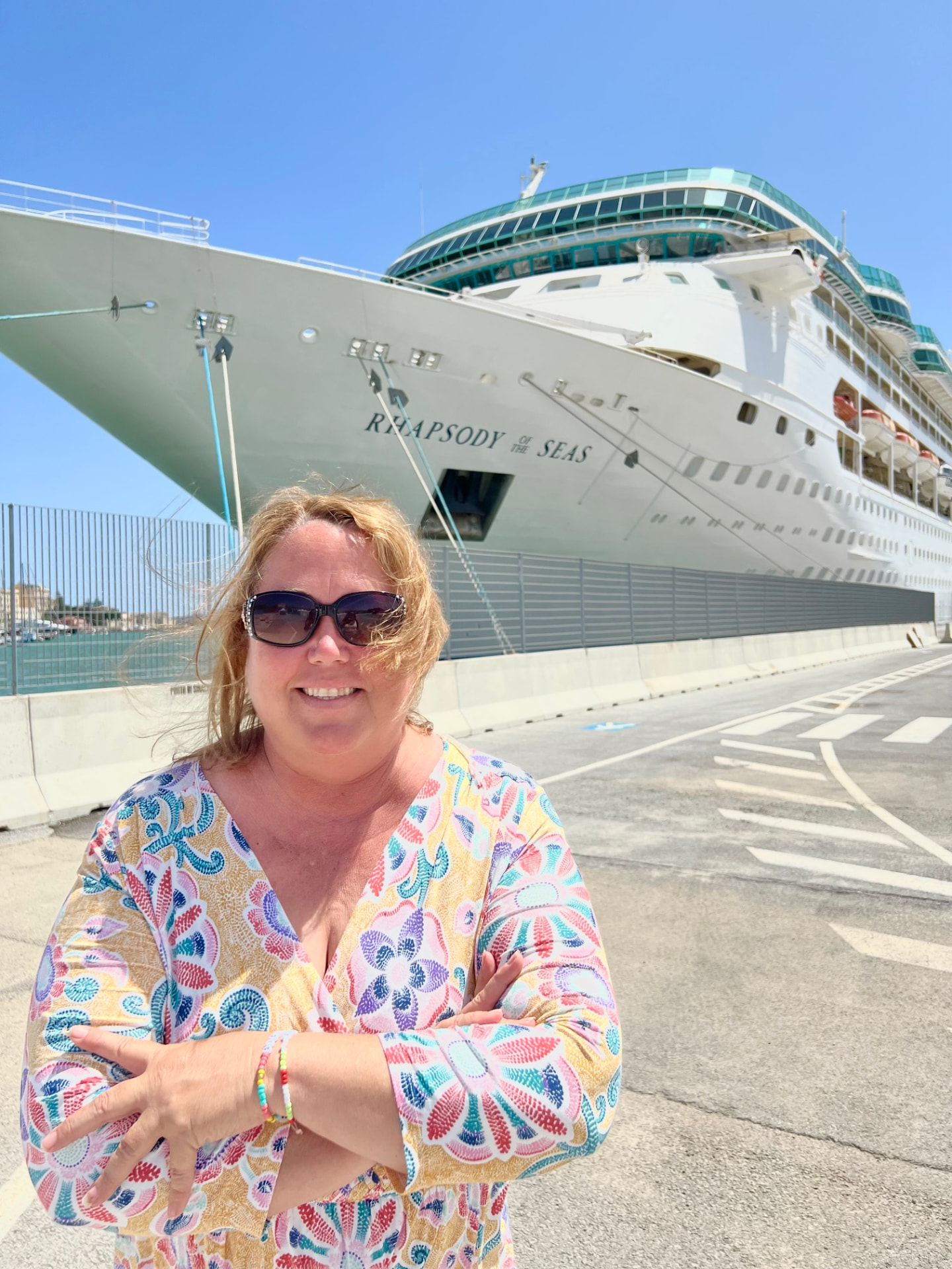 Christine Scheeler in front of the Rhapsody of the Seas cruise ship