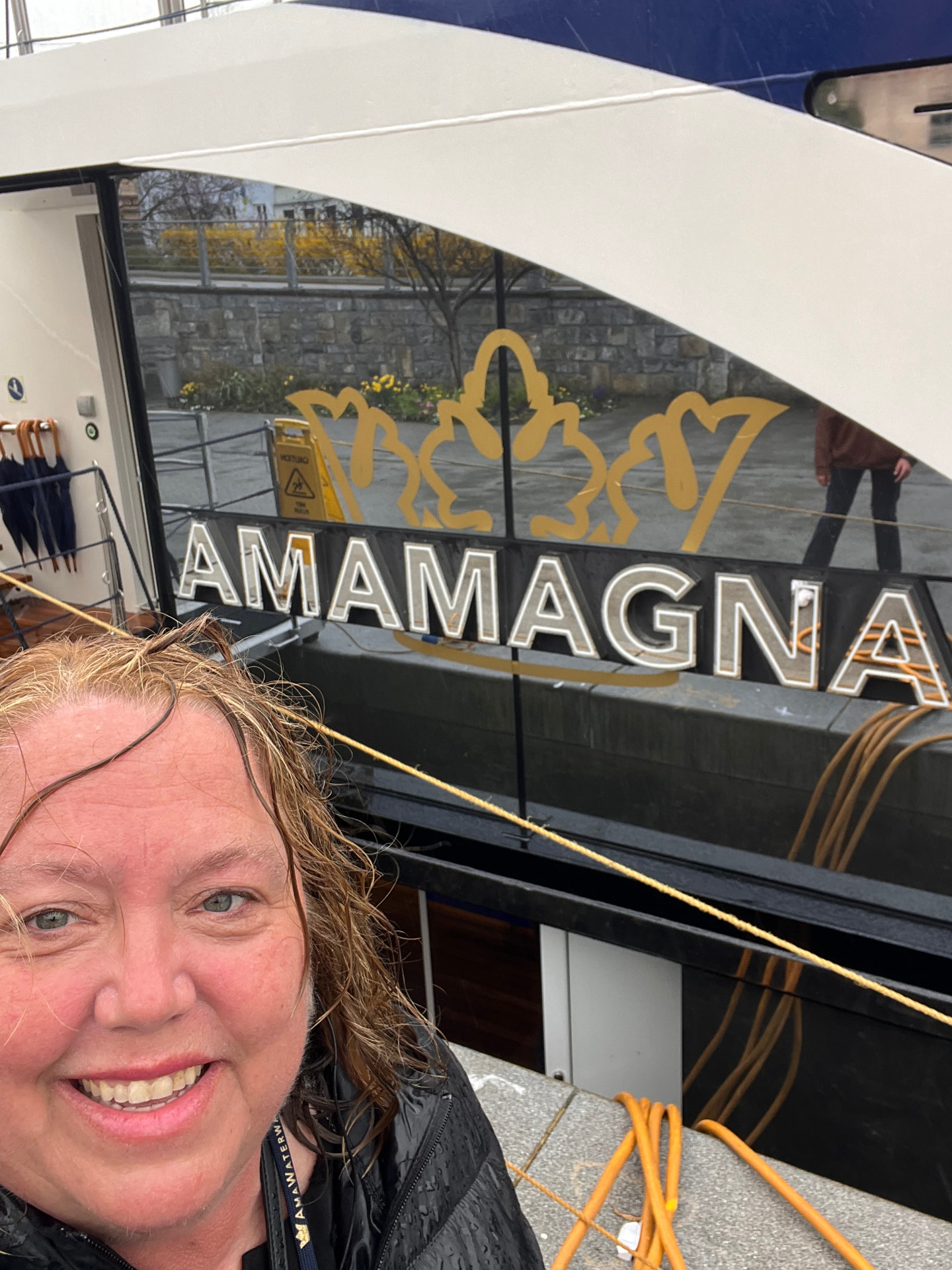 Christine beside AmaWaterways' AmaMagna river ship on a rainy European river dock